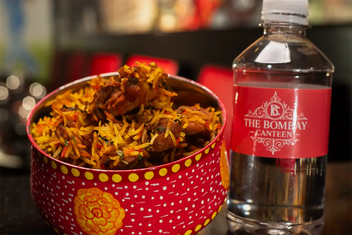 a rice dish and bottled water from Bombay Canteer