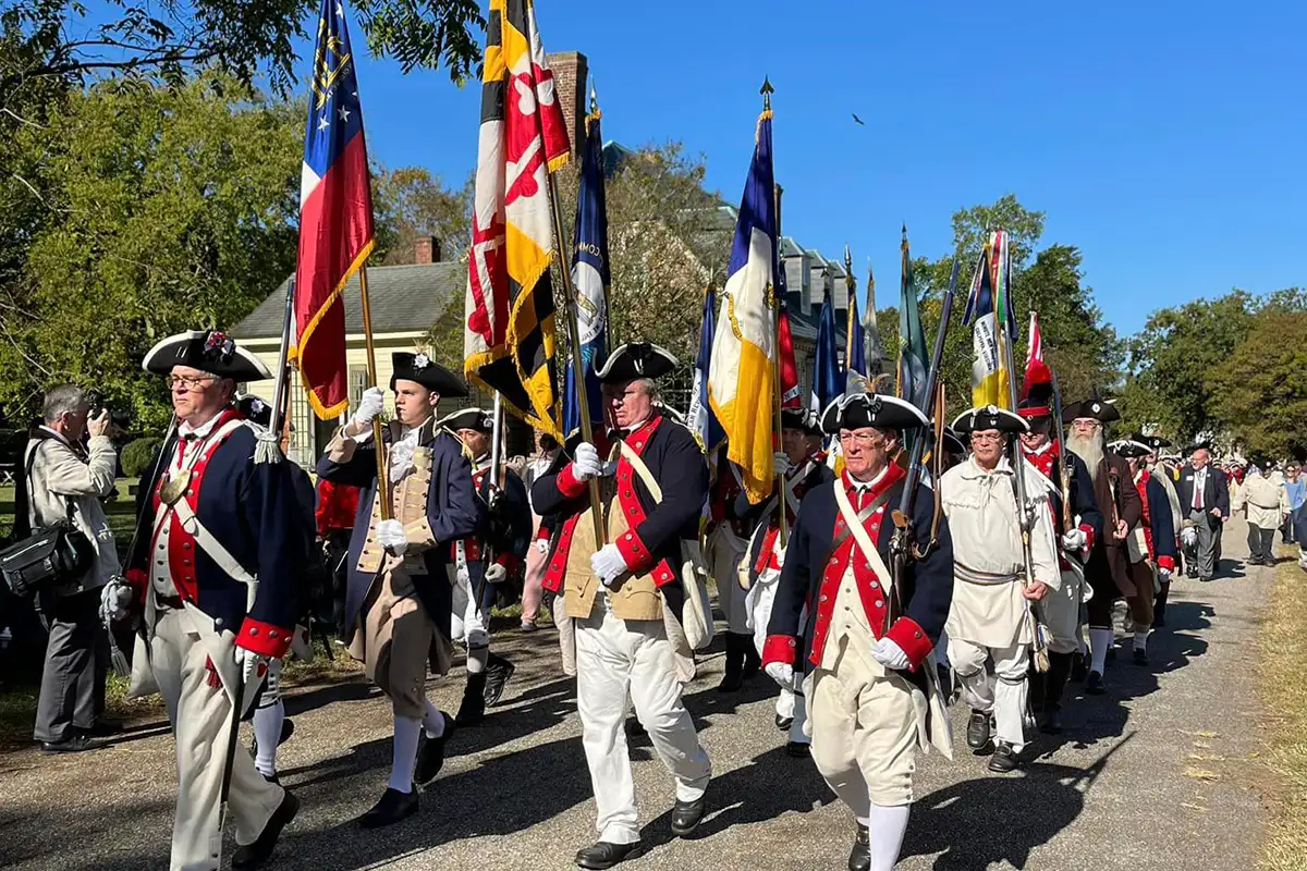 Yorktown Parade soldiers marching with flags reenactment