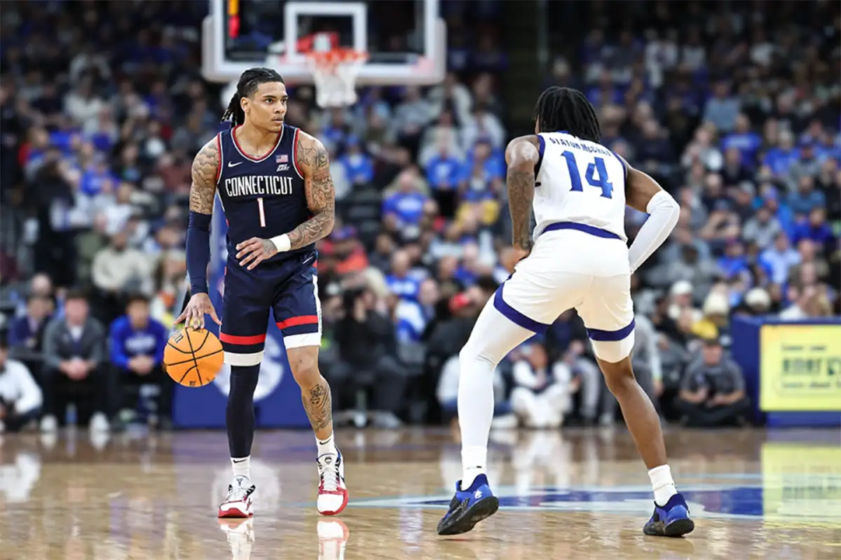 UConn Huskies guard Solo Ball (1) dribbles up court while Seton Hall guard AJ Staton-McCray (14) plays defense at Prudential Center.