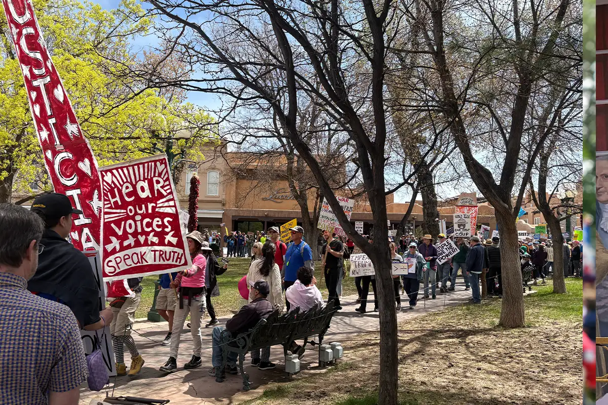 people sit and march at a No Kings rally
