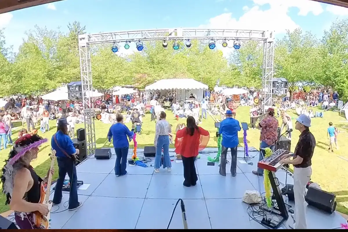 a band on stage in front of a festival