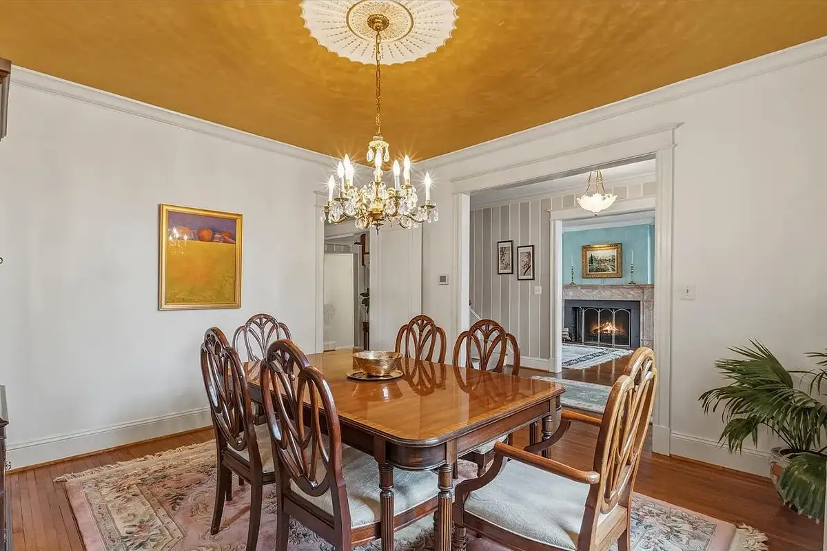 Dining room with yellow ceiling and chandelier