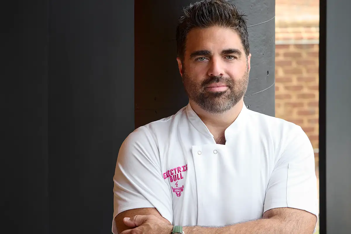 Chef Victor Albisu in a white Electric Bull chef uniform