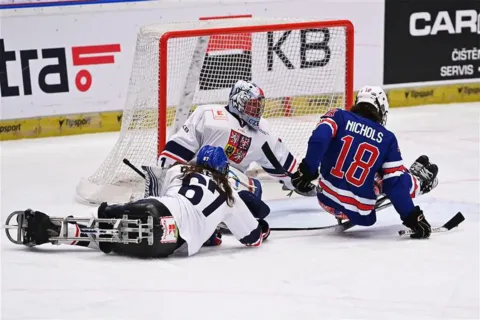evan nichols on ice during sled hockey game