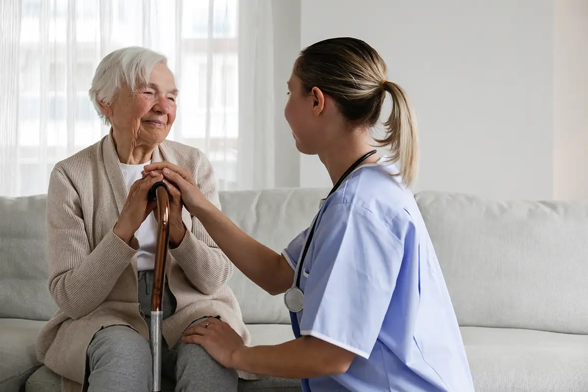 Elderly woman receiving medical care from nurse