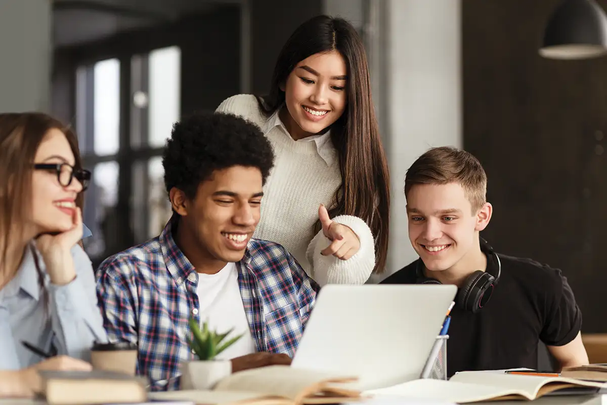Students looking at laptop