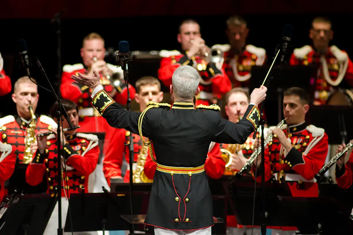 Man conducting wind ensemble at Blast Off: The President's Own United States Marine Band