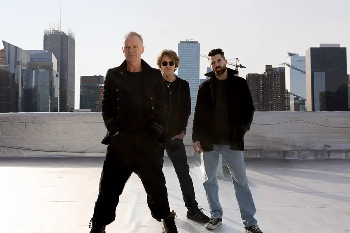 Sting and crew posing on rooftop