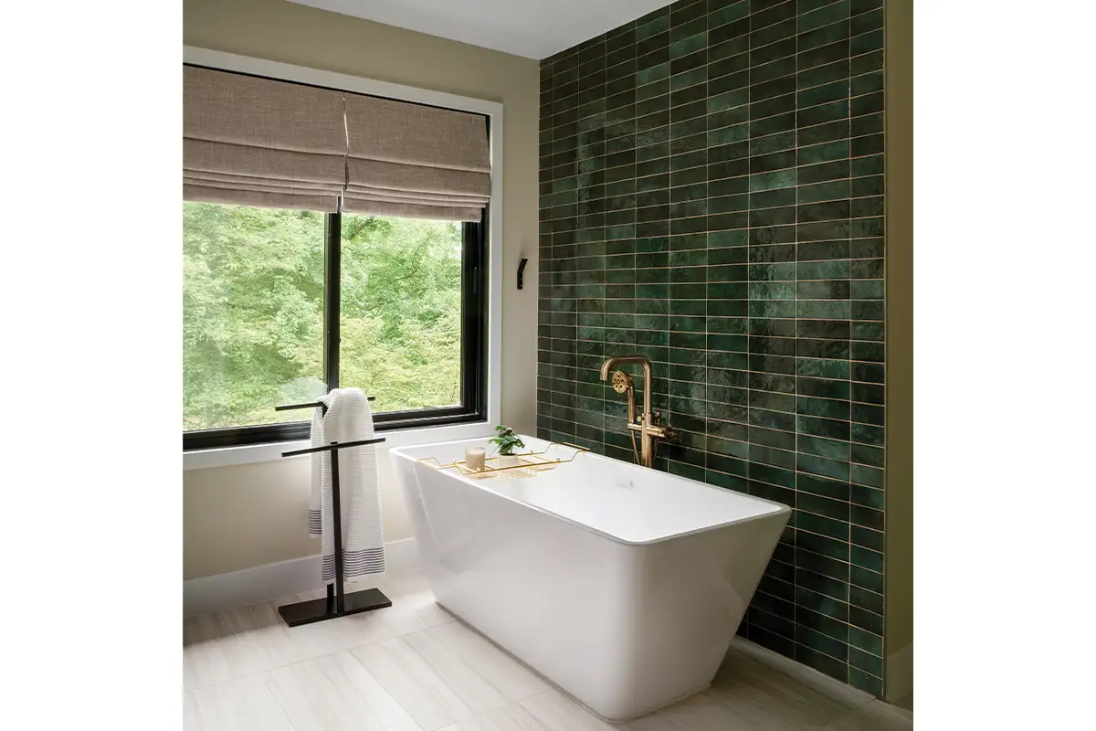 The tub feature wall is Lume Collection Zellige tiles in green. Plumbing fixtures are by Brizo and lighting is by Mitzi. 
Cabinetry was done by Batu Homes + Remodeling