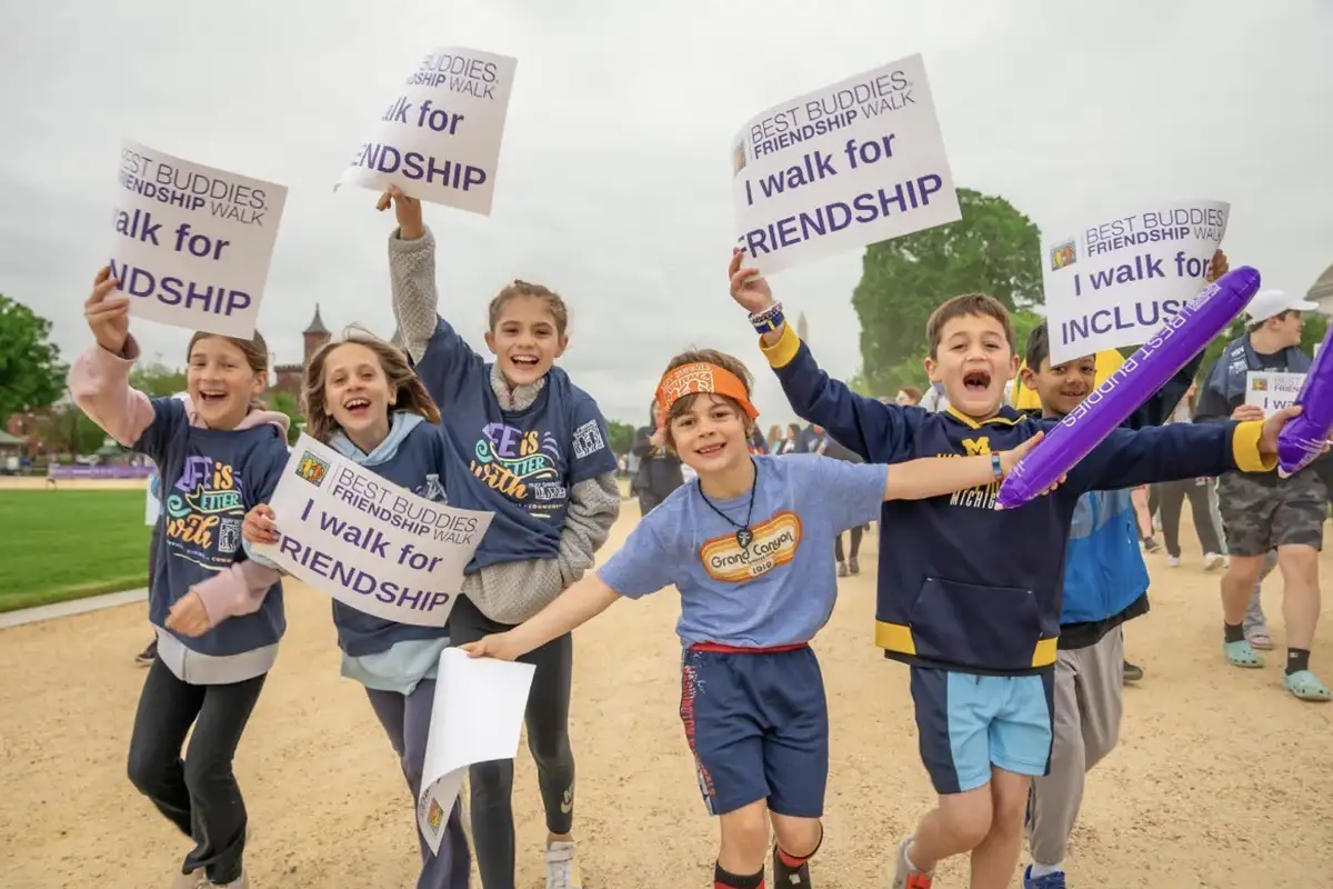 Kids running with signs at Best Buddies Friendship Walk on National Mall