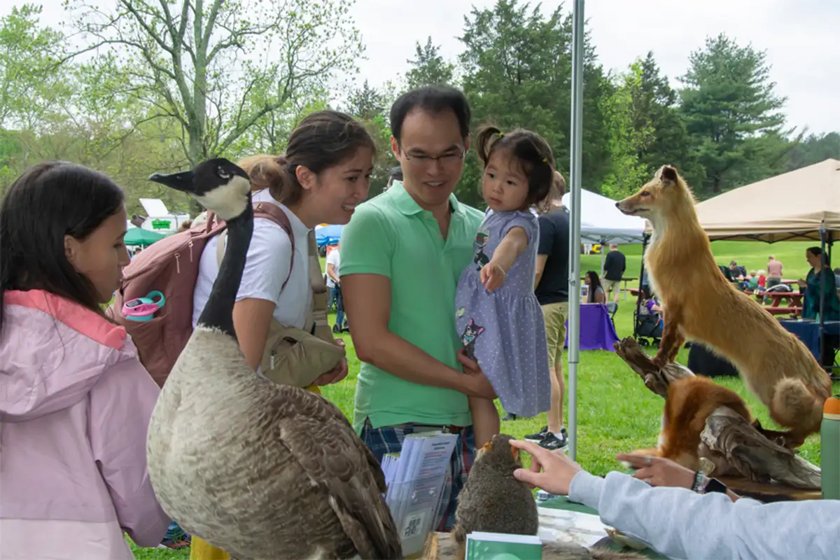 Family at animal booth at Earth Day Fairfax