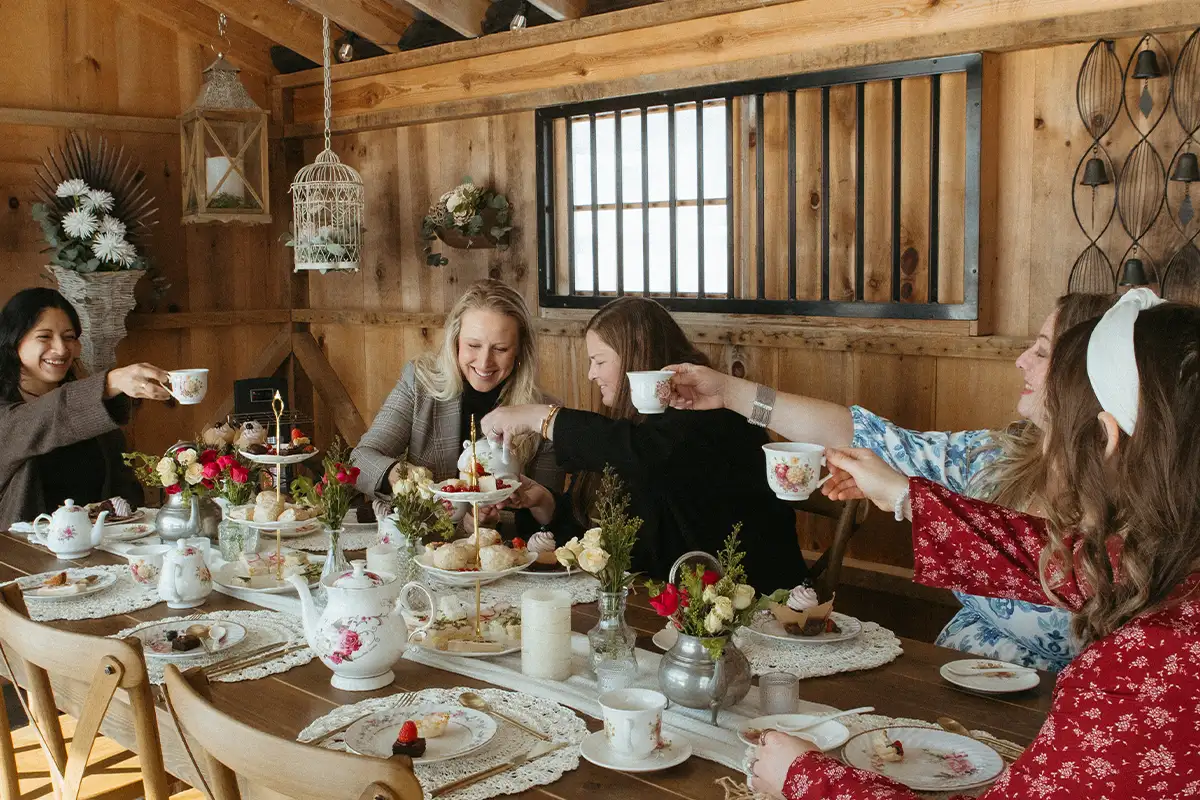 Women sit around a table having team at Scarlet Springs Farm