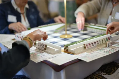 Close up of people playing mahjong at Cana Vineyards