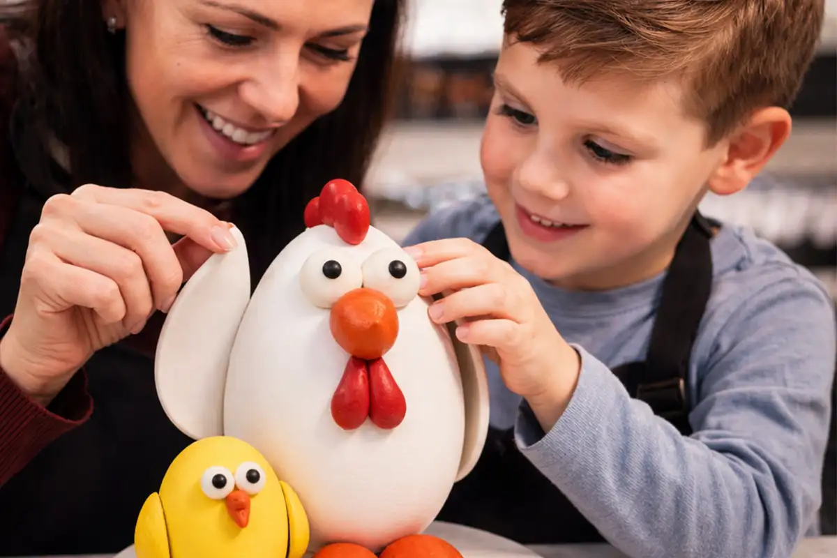a mother and son decorate a chocolate chicken and chick