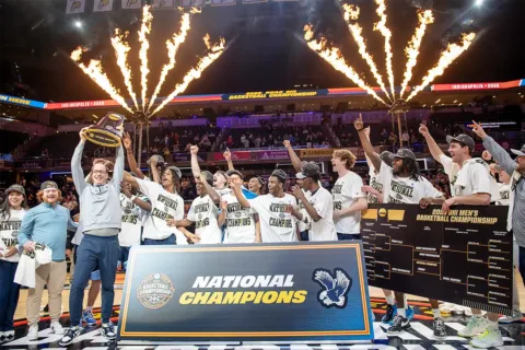 UMW men's basketball team players and coaches celebrate winning the D3 national championship