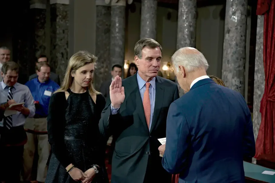 Madison Warner, left, and Mark Warner as he is sworn in by Joe Biden in 2015 (Mark Reinstein/MediaPunch)