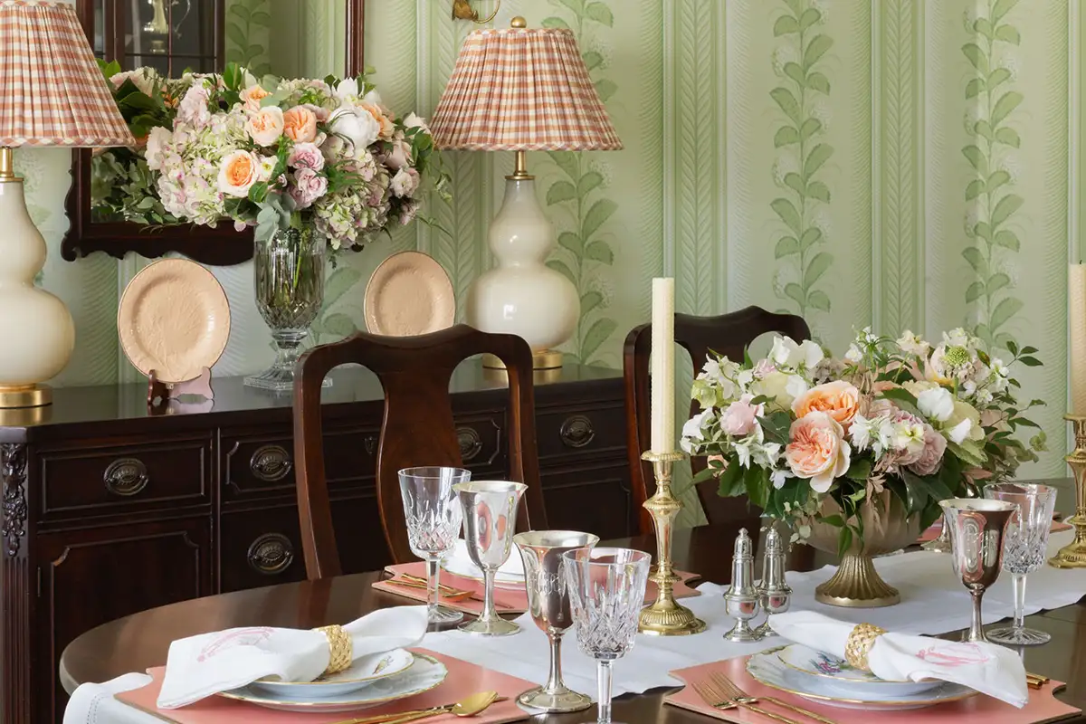 Interior dining room with green wallpaper and dark wood furniture of the Merchant family home in Alexandria