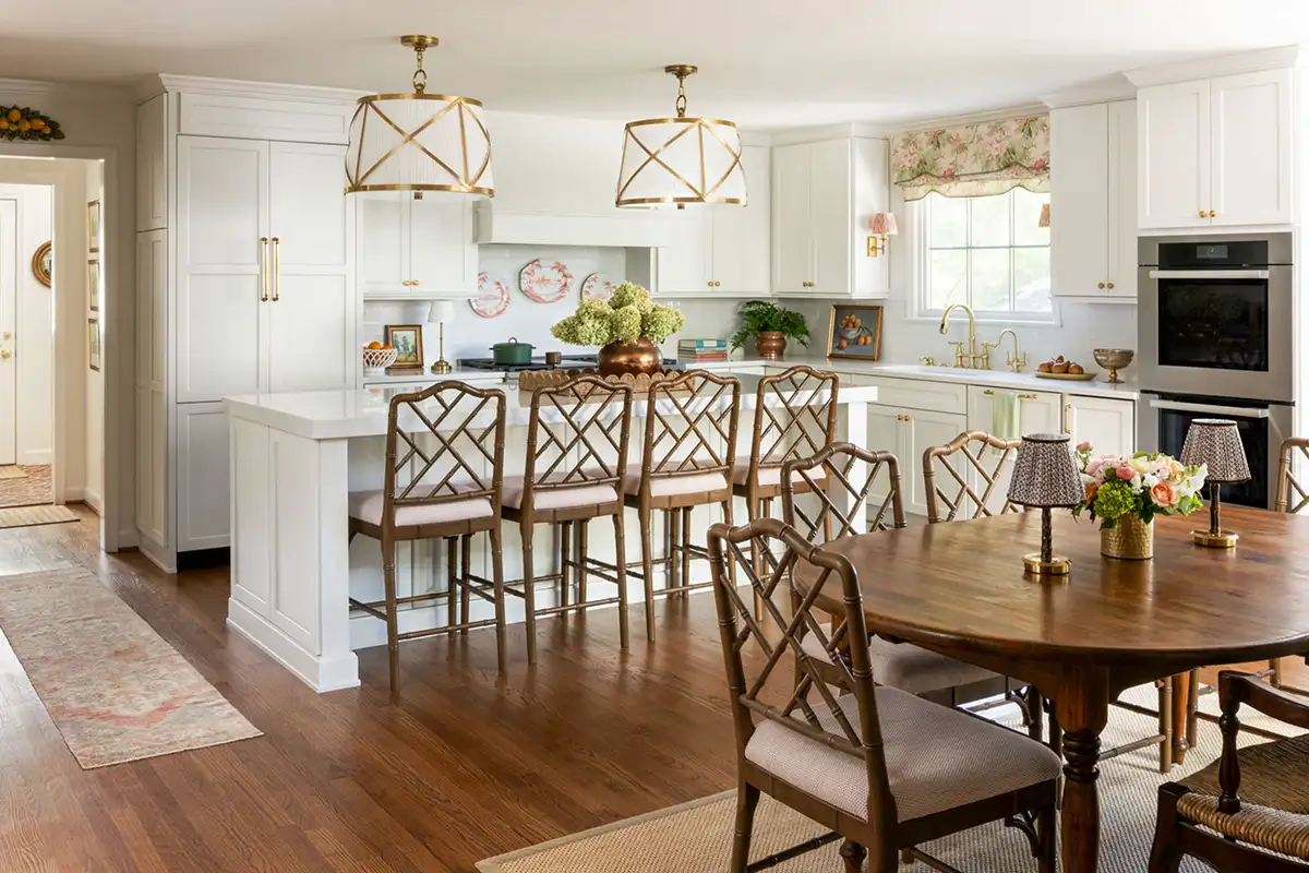 Kitchen and eat-in area interior with wooden furniture and gold accents of the Merchant family home in Alexandria