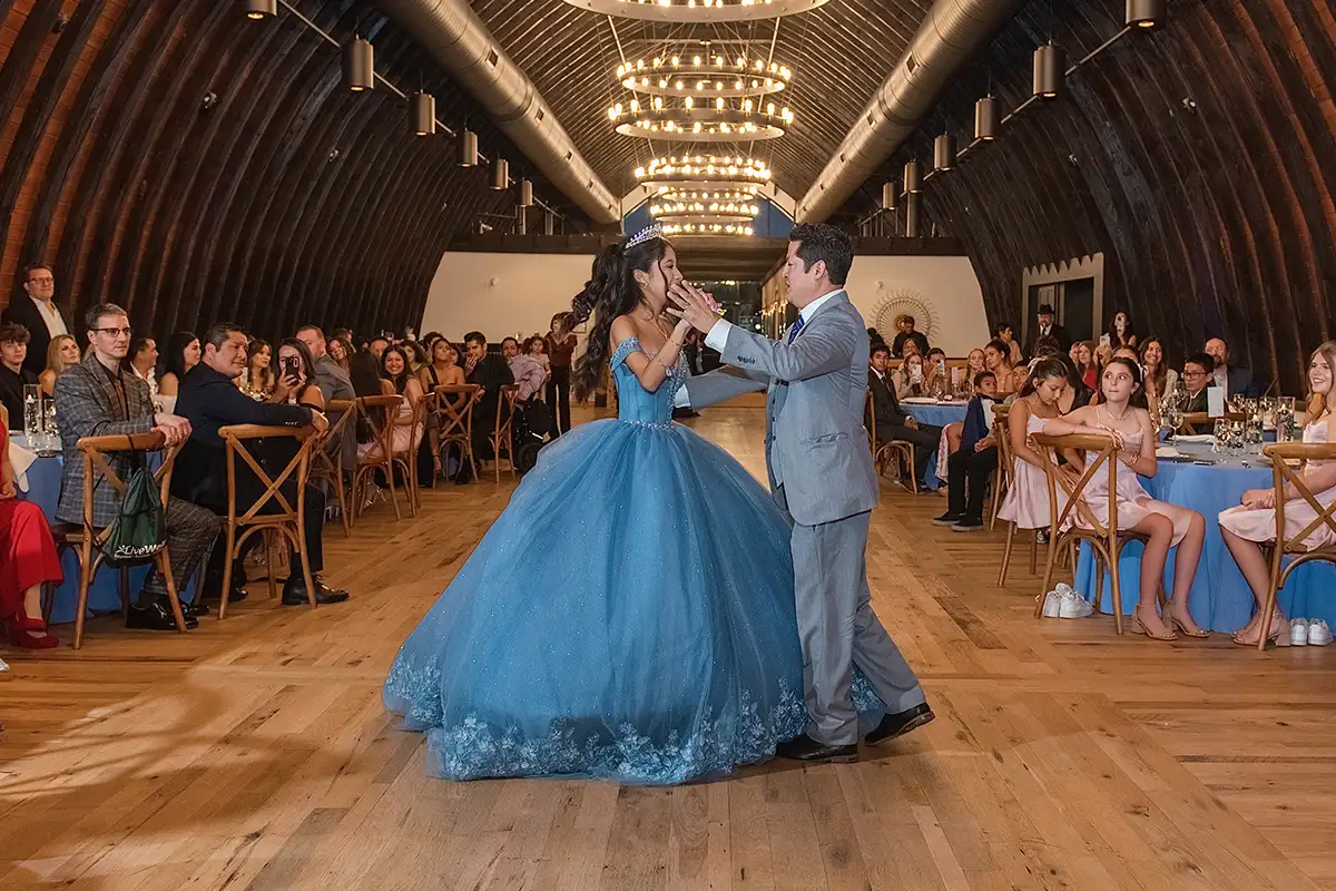 Girl and her father dancing at quinceañera