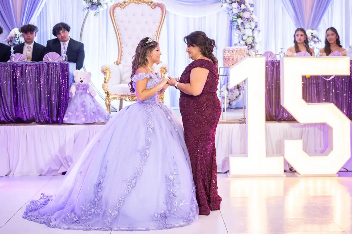 Girl and her mother dancing at quinceañera