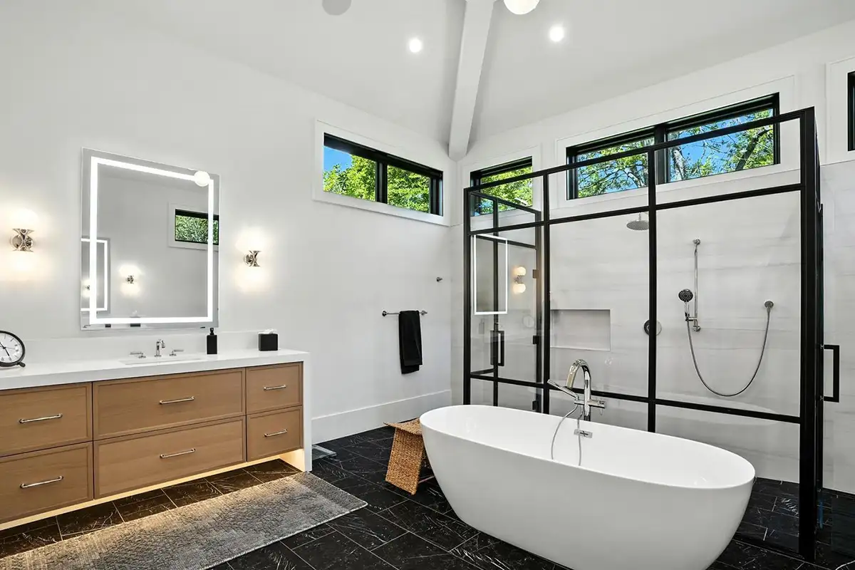 Primary bathroom with a double vanity, free standing shower, and soaking tub of 1200 Jossie Lane.
