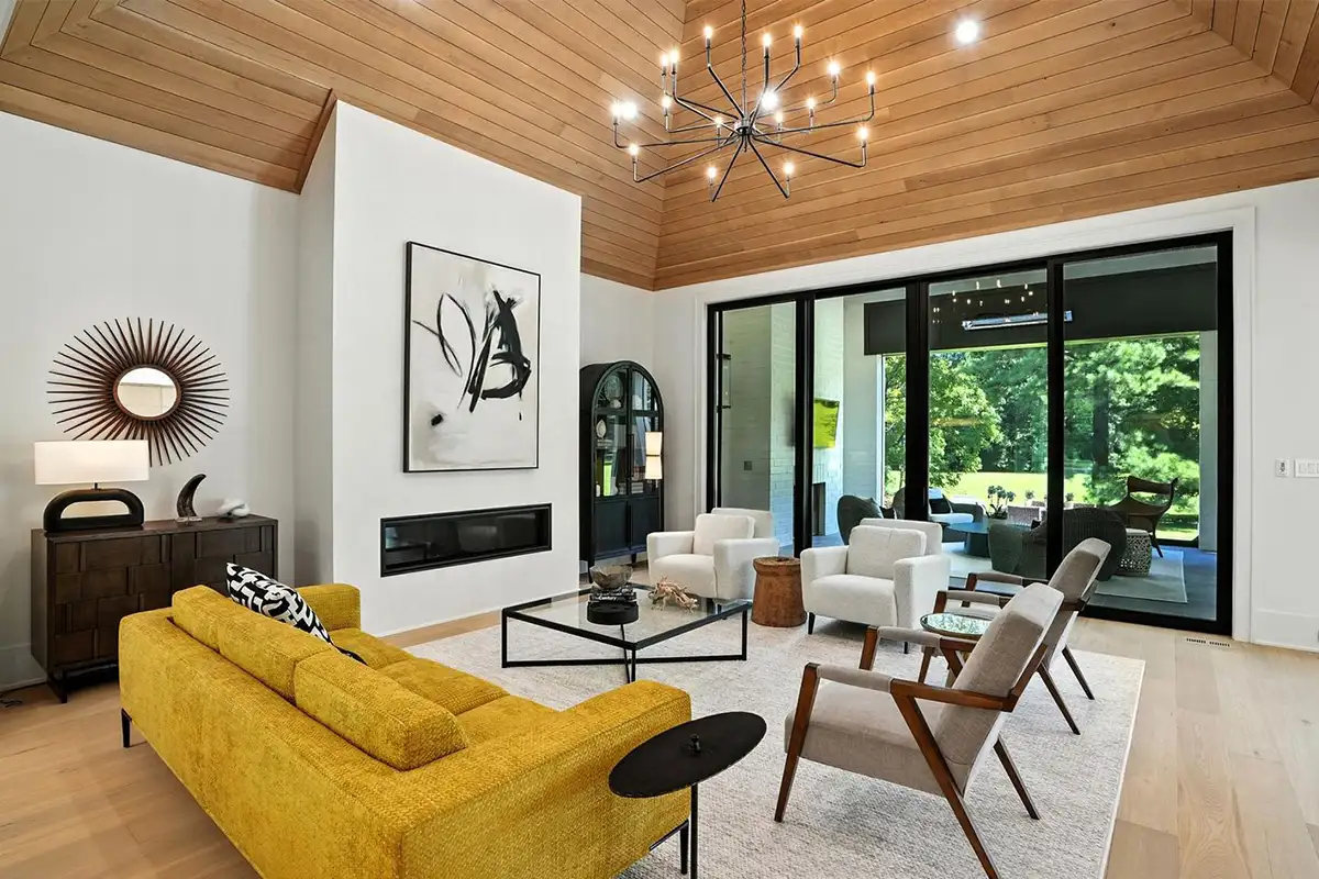 Living room with high ceilings, a fireplace, and large glass sliding doors of 1200 Jossie Lane