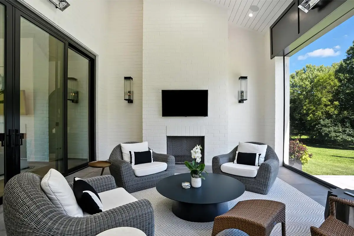 Screened porch with a fireplace, heaters, skylights, and motorized screen of 1200 Jossie Lane.