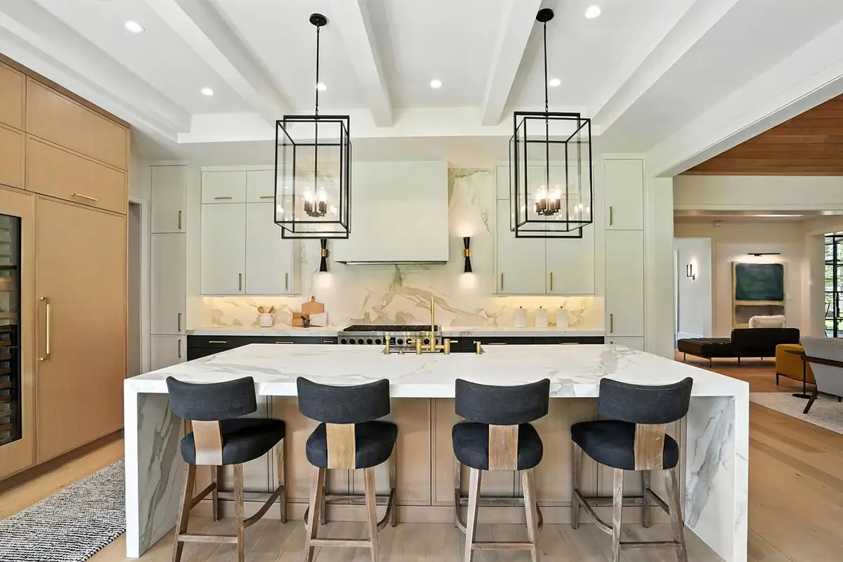 Kitchen with a marble island, wine refrigerator, and modern light fixtures of 1200 Jossie Lane
