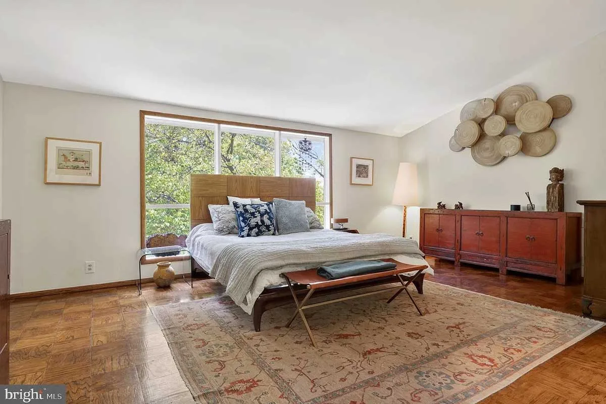 primary bedroom with bedframe against window