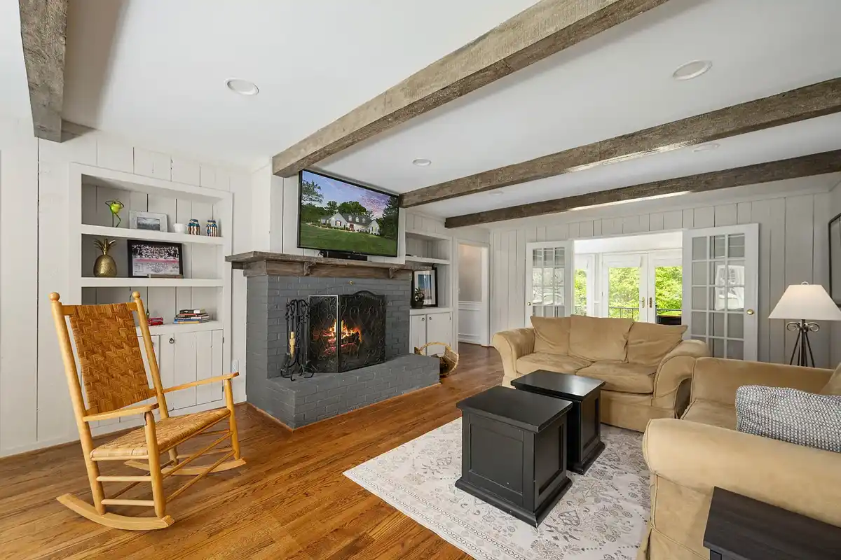 family room with wood beam accents along ceiling