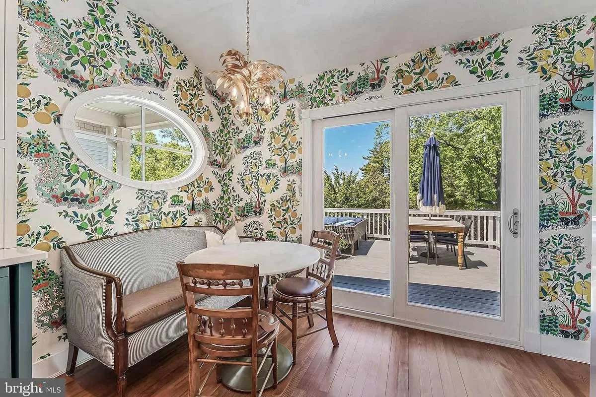 dining nook with custom wallpaper and view of back deck