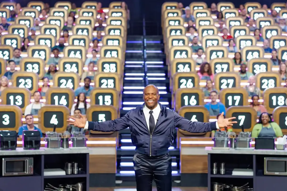 Terry Crews stands on the set of the Food Network show 100 Cooks