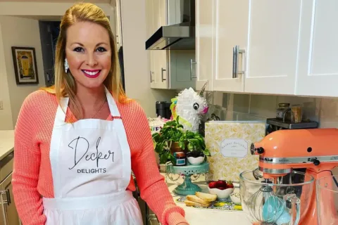 Alexandria resident Amy Decker in an apron in her kitchen