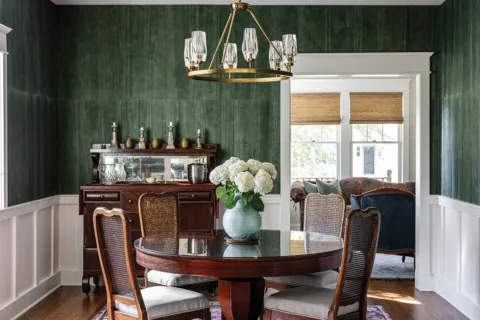 Room with green wallpaper and antique furniture