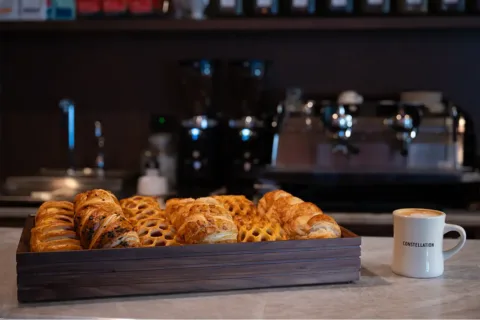 Box of pastries and a cup of coffee from Constellation at National Landing