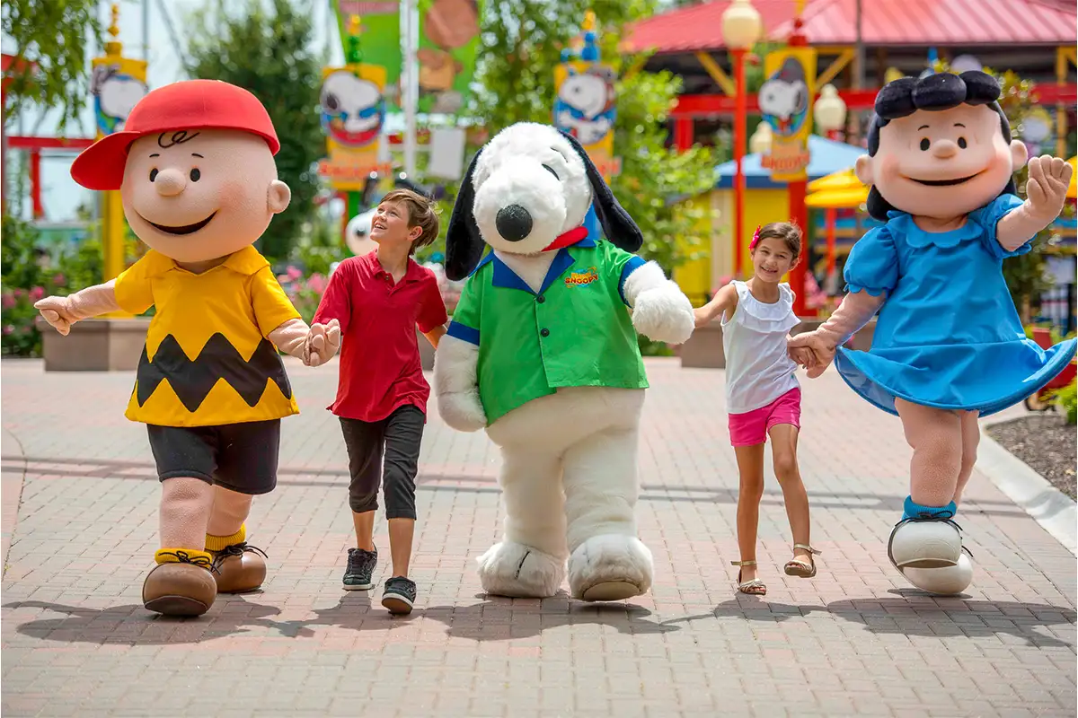 kids walk with Charlie Brown, Lucy and Snoopy characters are Kings Dominion