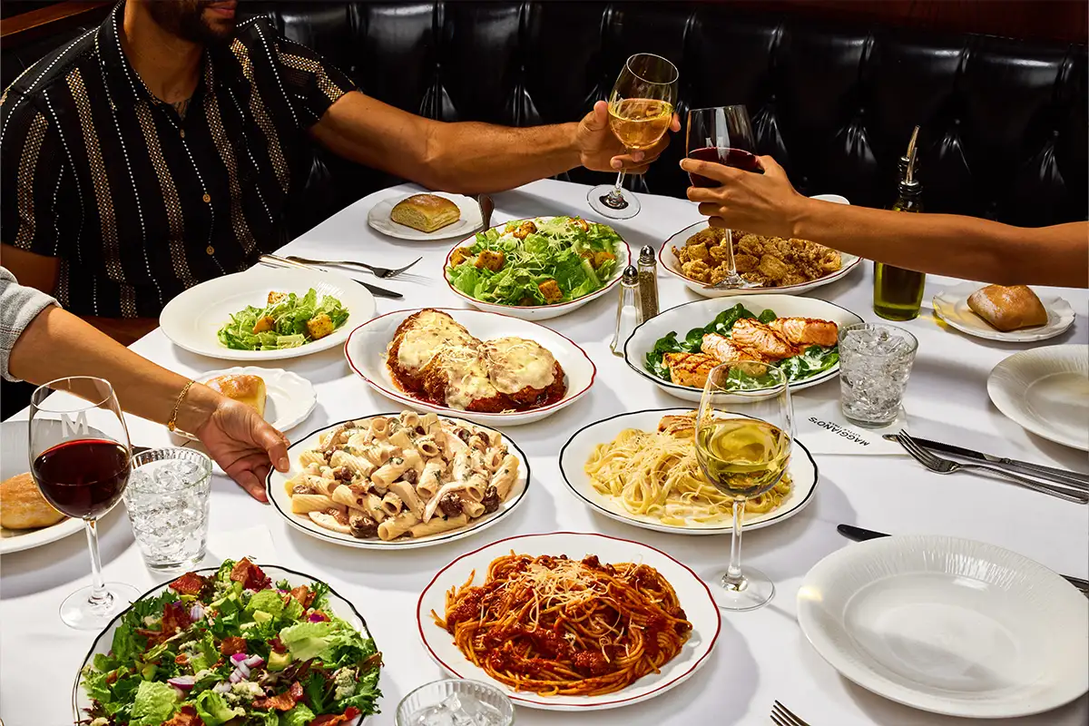 a table full of Italian food at Maggiano’s Little Italy