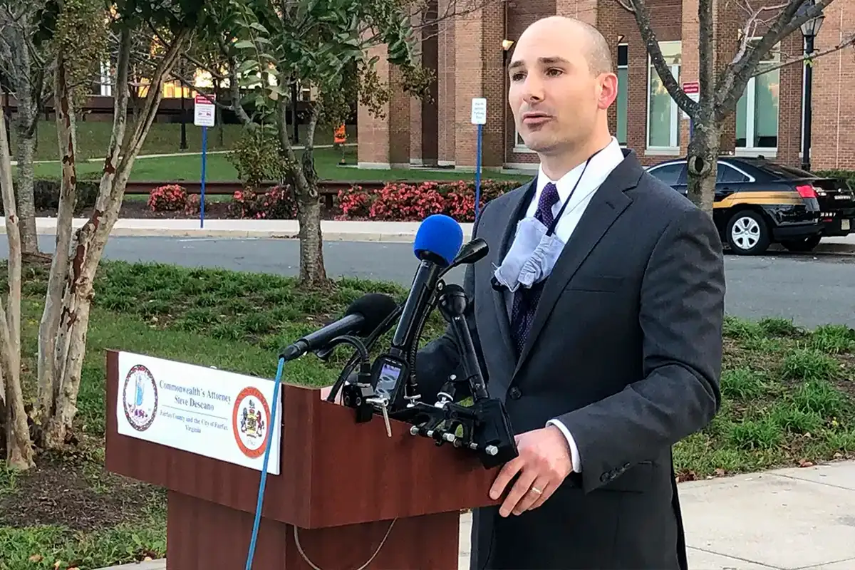 Fairfax County Commonwealth’s Attorney Steve Descano talks at an outdoor lectern