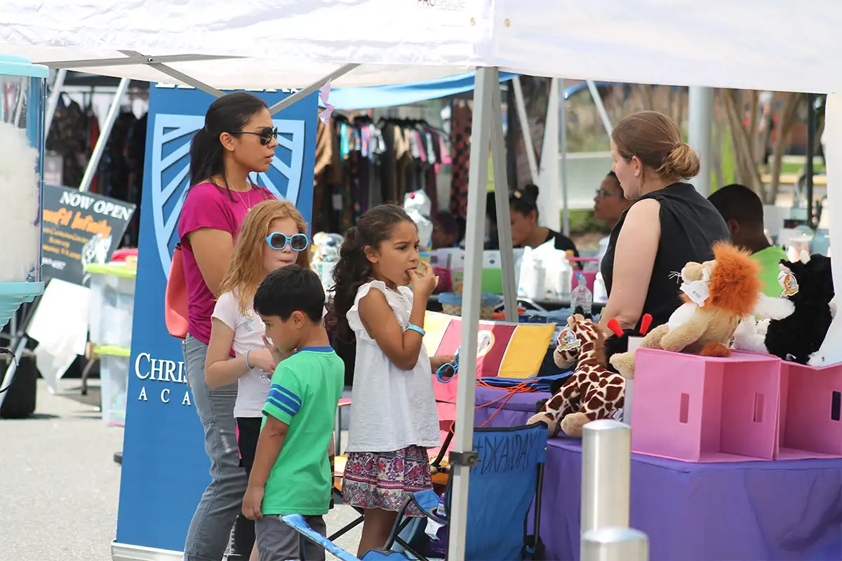 Visitors shopping at local vendor booths at Taste of Woodbridge