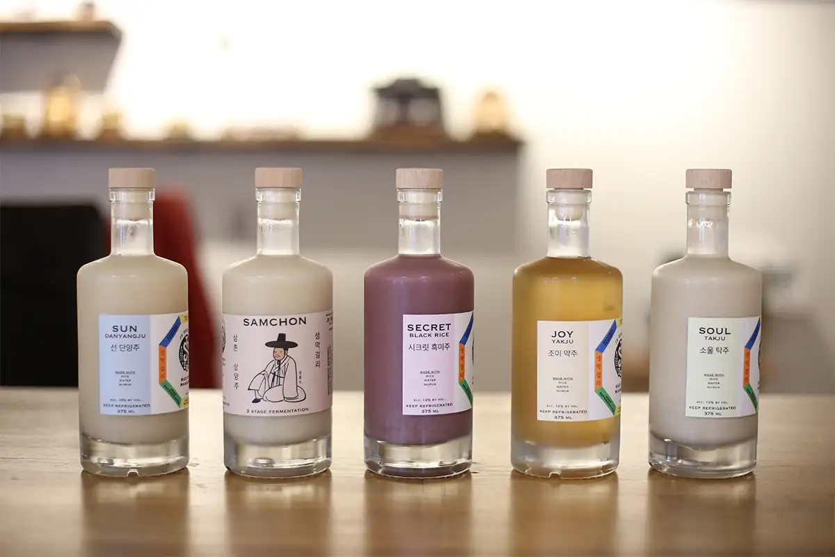 Five staged bottles of JS Brewery Korean Rice Wine