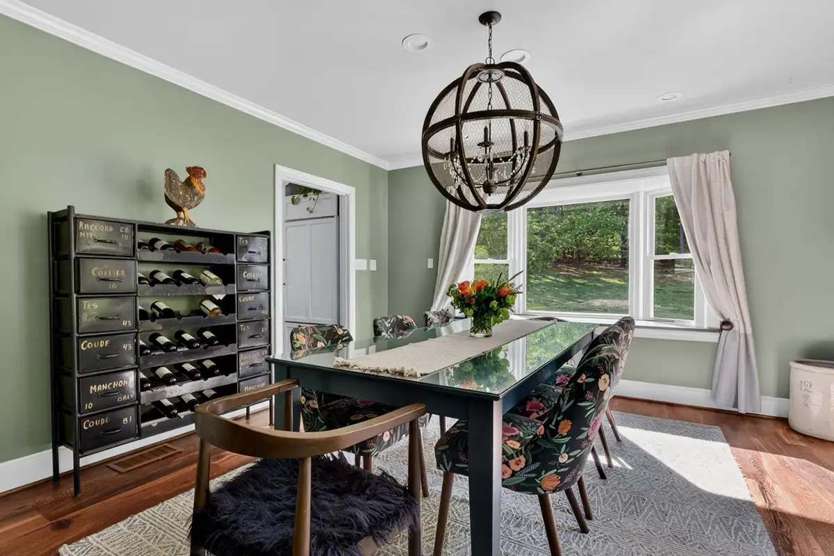 Dining room with wide-plant flooring, small bay window, and rustic lighting of 3204 Mountain Rd