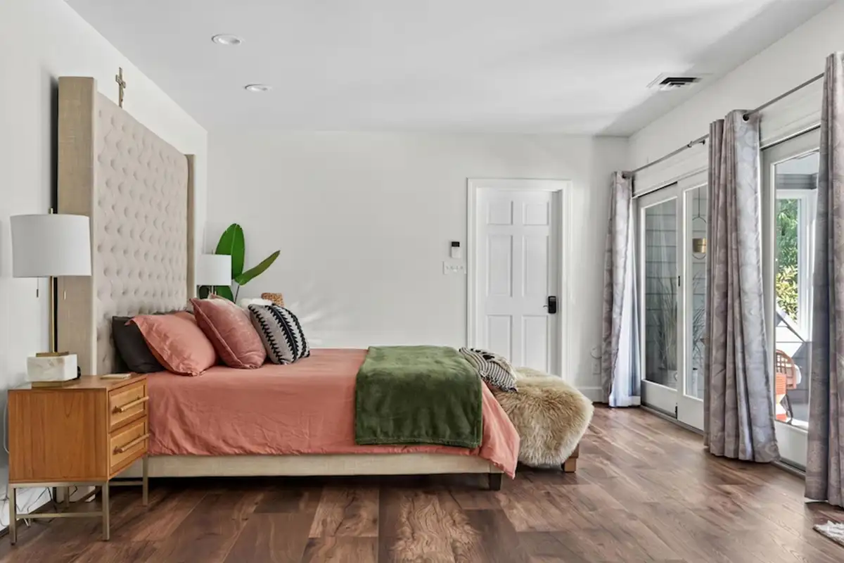 Primary bedroom with sliding doors leading to small porch of 3204 Mountain Rd