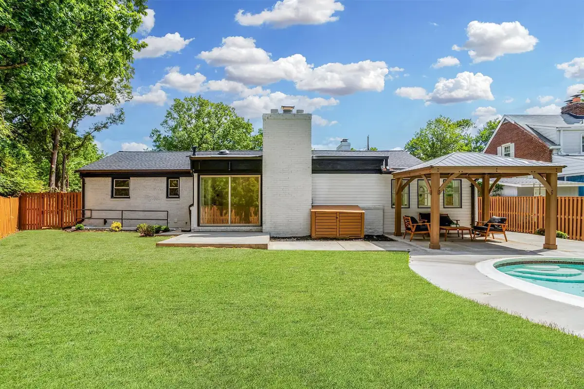 Backyard exterior with inground pool, gazebo, patio, and fenced in yard of 3504 Gordon St
