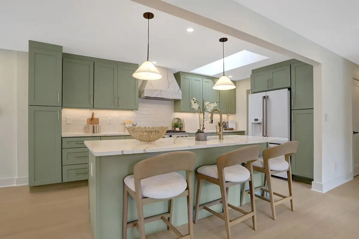 Kitchen with sage cabinets, quartz countertops, large pantry, and premium Cafe appliances of 3504 Gordon St