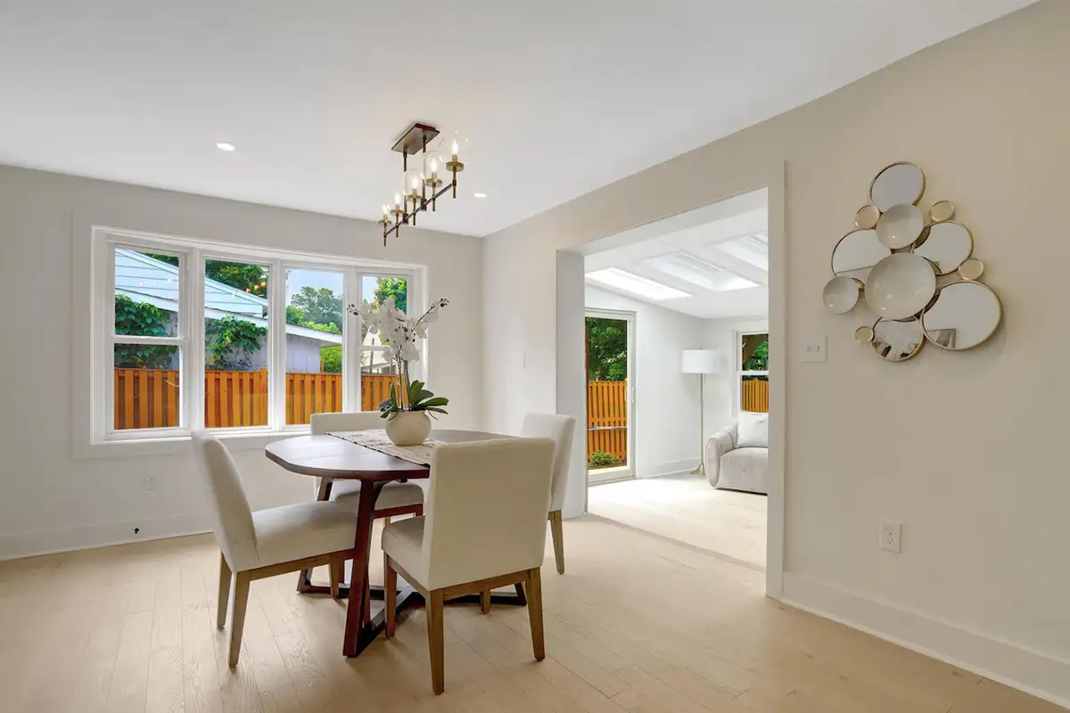 Dining area with large windows, white oak flooring, and an open concept of 3504 Gordon St
