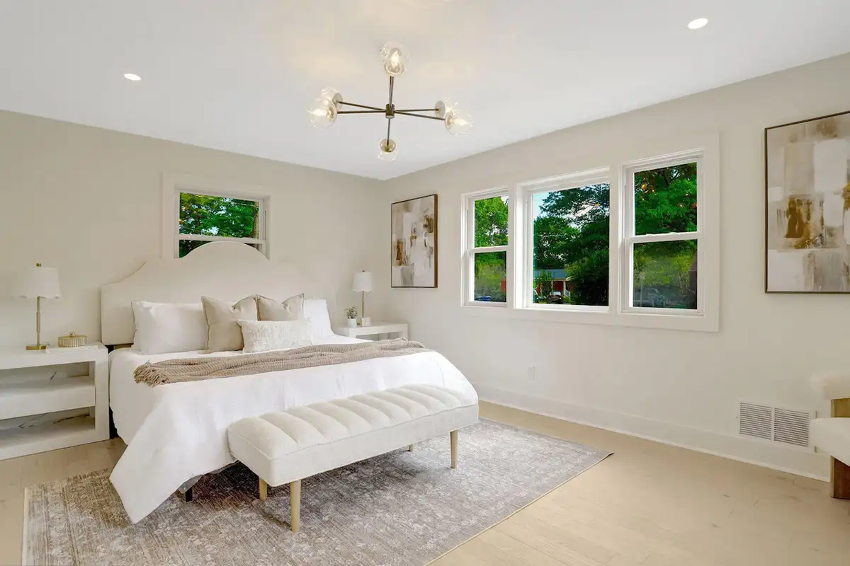 Primary bedroom with large windows, modern light fixtures, and white oak flooring of 3504 Gordon St