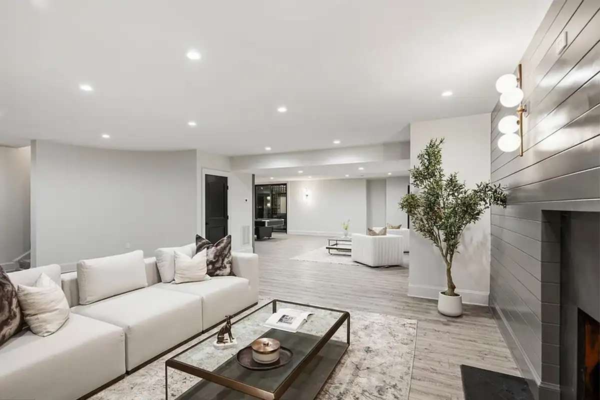 Finished basement with fireplace, wine cellar, fitness room, home theatre, bedroom and bathroom, and game room of 4614 36th St N