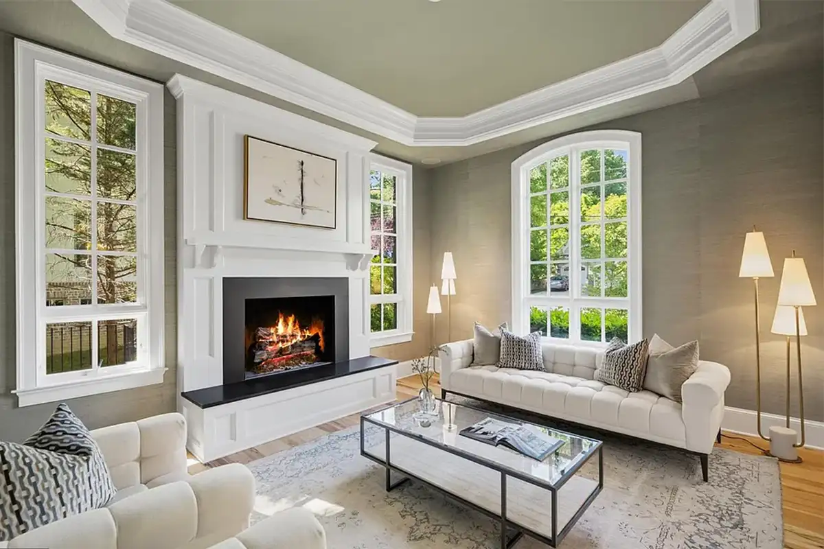 Living room with masonry fireplace, tall windows, and crown molding of 4614 36th St N