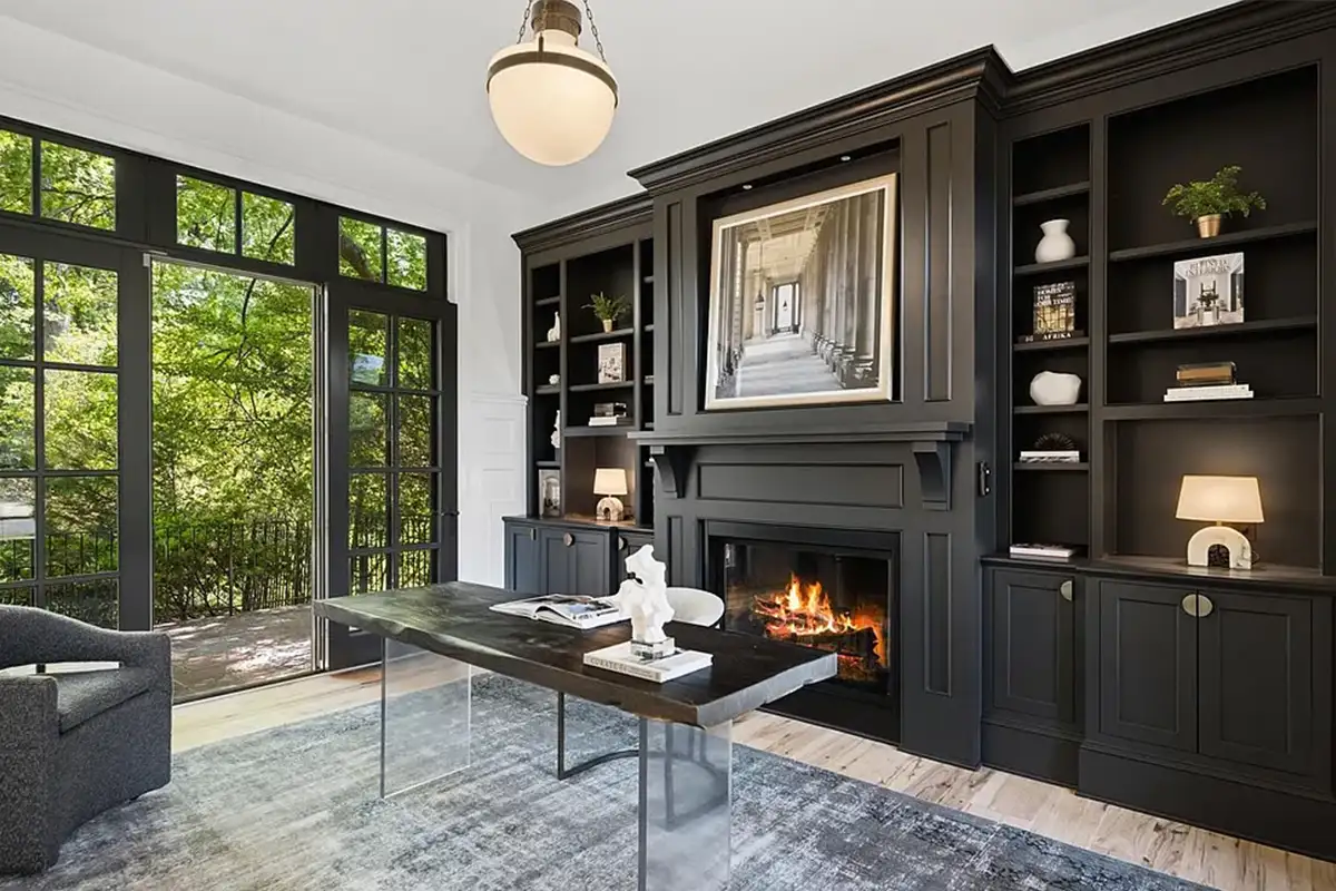 Private library with built in walls, masonry fireplace, and sliding doors leading to the backyard of 4614 36th St N