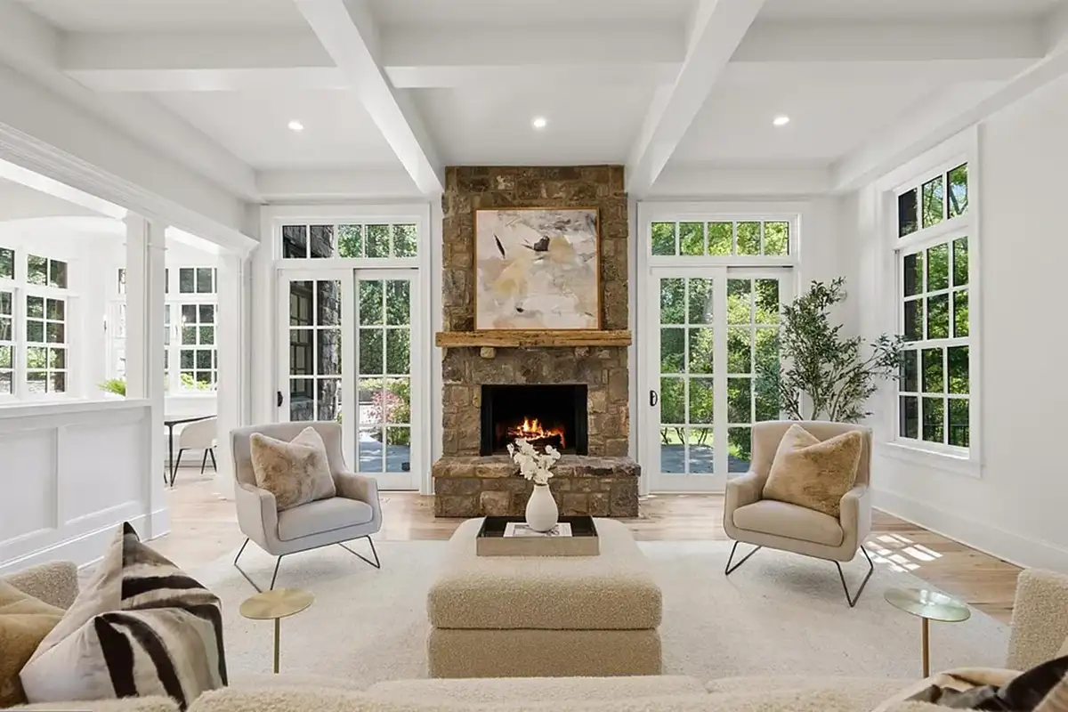 Family room with stone fireplace, sliding doors, and wide-plank flooring throughout of 4614 36th St N